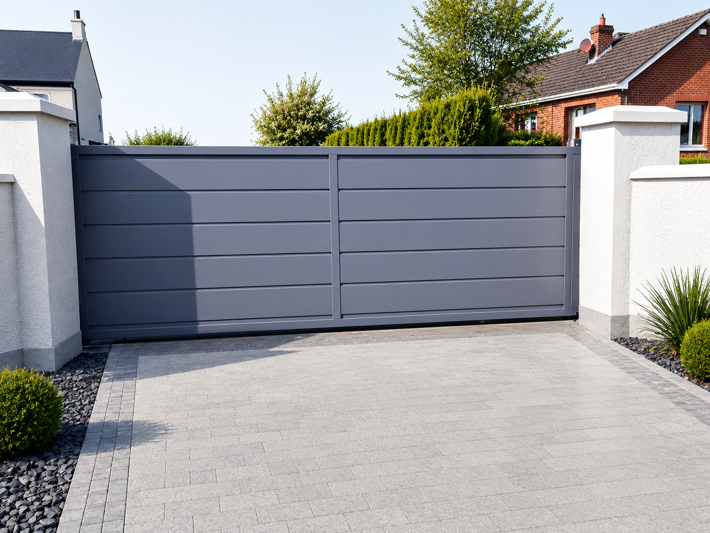 Grey electric sliding gate at a modern home