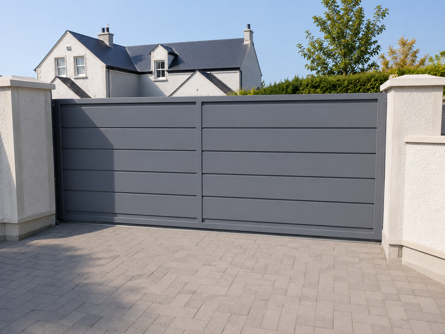 Automated modern double swing gates in grey on a residential driveway